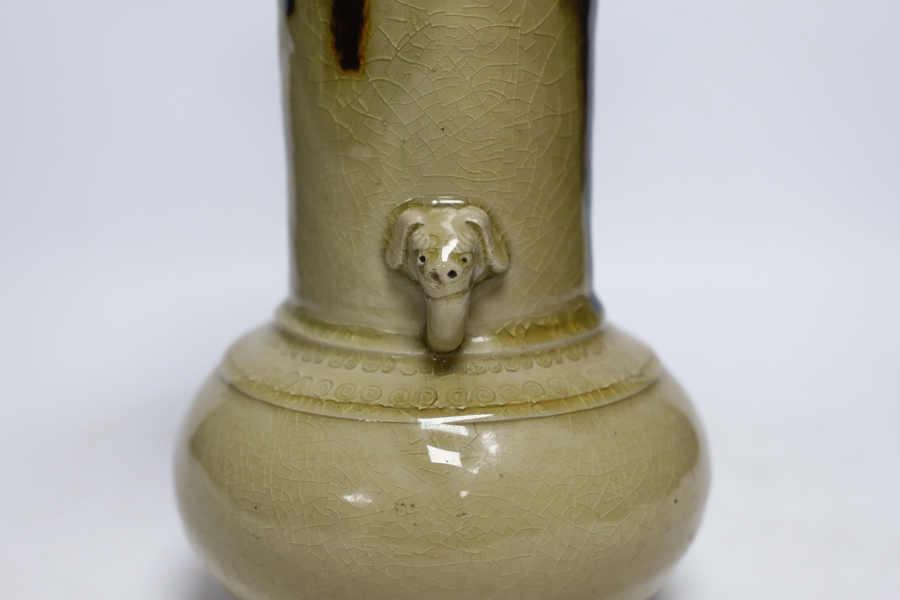 A Japanese celadon and brown glazed vase with mythical beast handles, 27cm